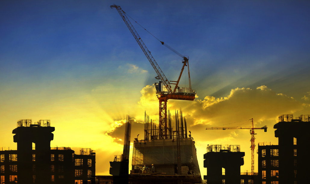 building and crane construction site against beautiful dramatic in dusky sky